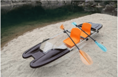 Recreational sit-on-top kayak with paddles on sandy shore