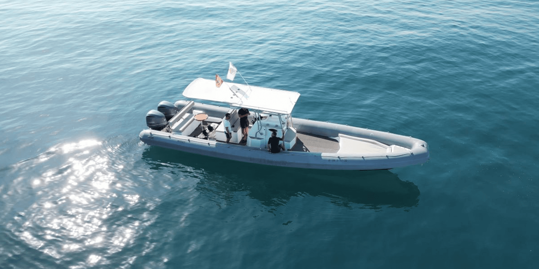 Aerial view of rigid inflatable boat (RIB) on open turquoise sea