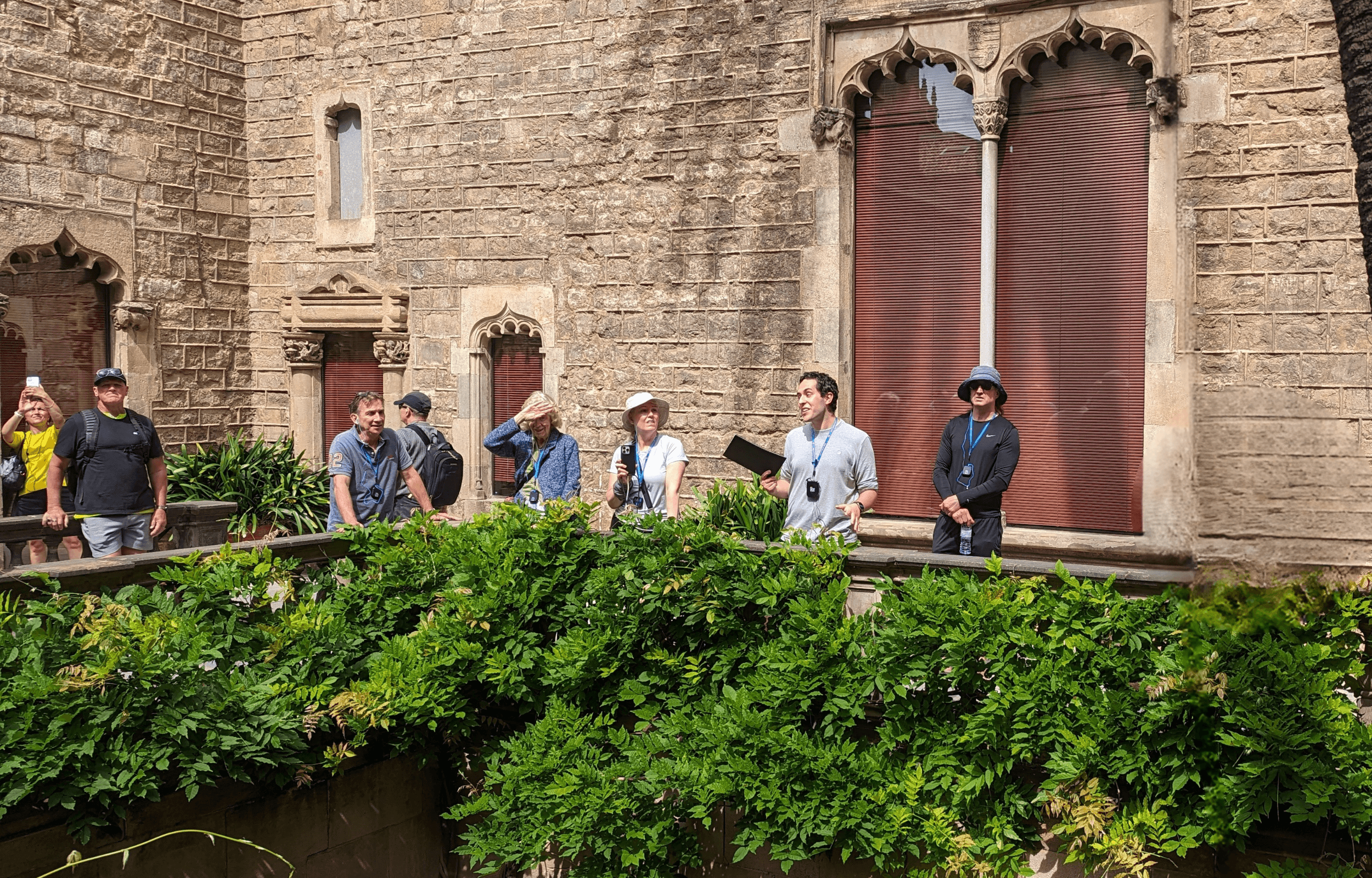 Guided group visiting medieval courtyard garden at landmark