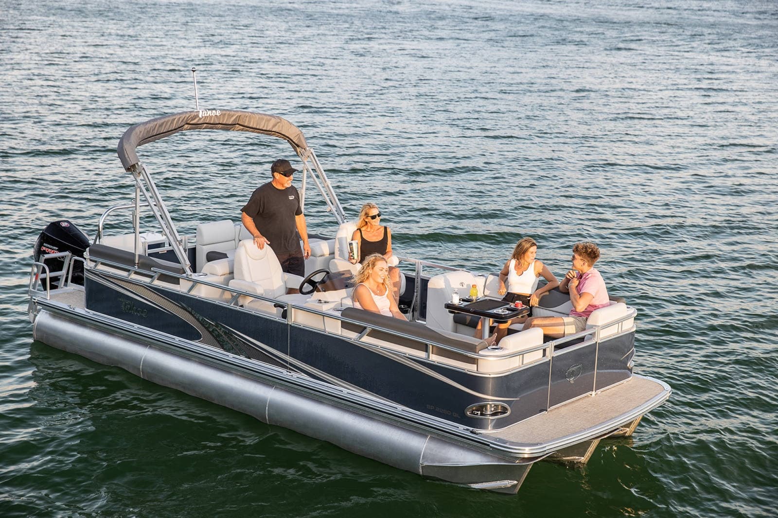 Pontoon boat rental cruising on scenic lake in Idaho with passengers