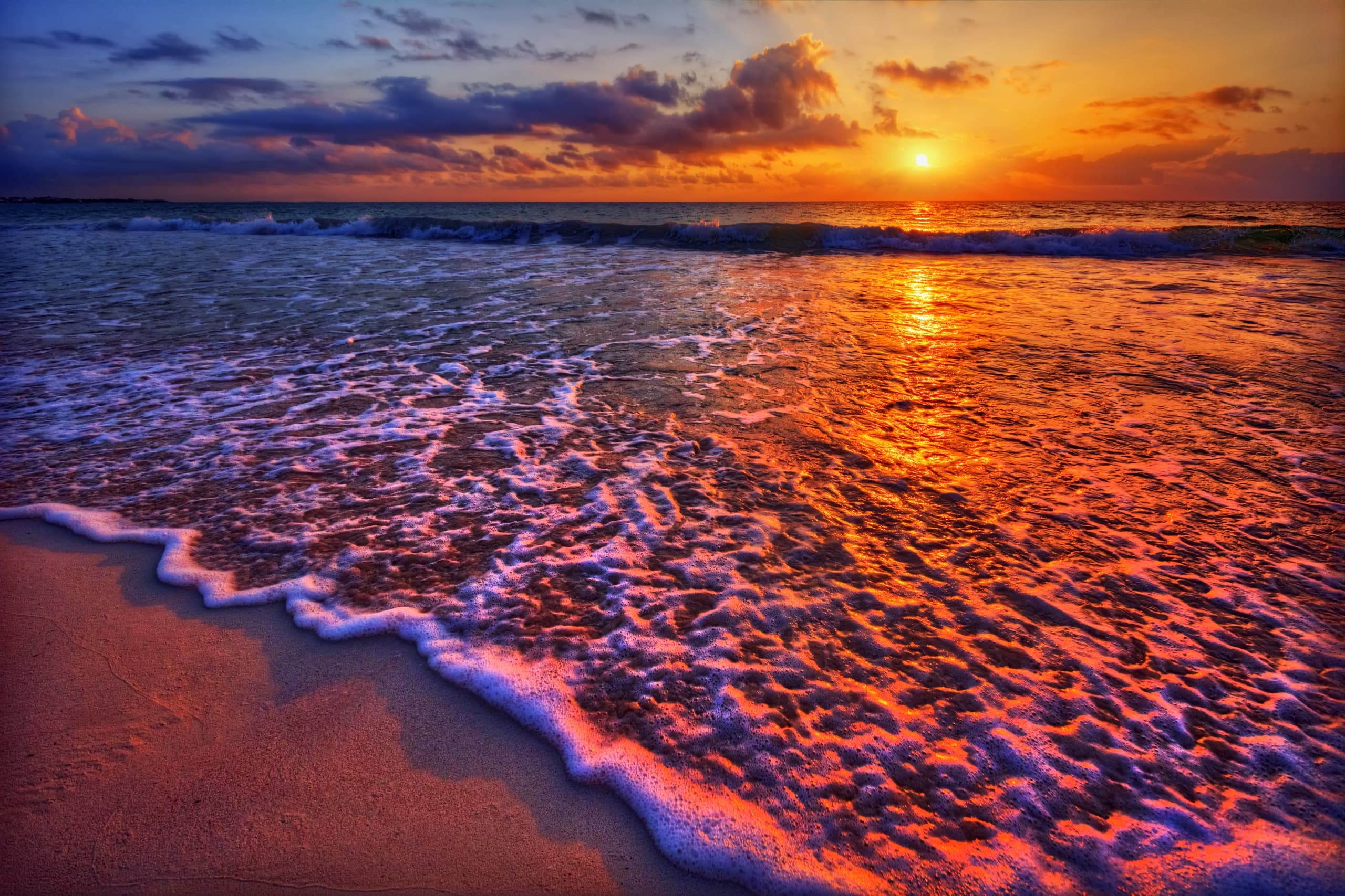Dramatic beach sunset with vivid sky and glowing shoreline
