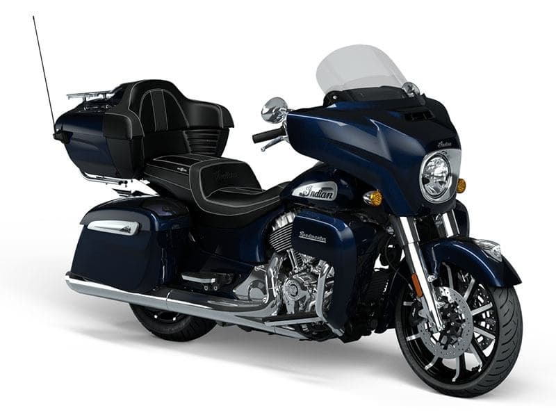 Blue touring motorcycle on white studio backdrop, road-ready cruiser