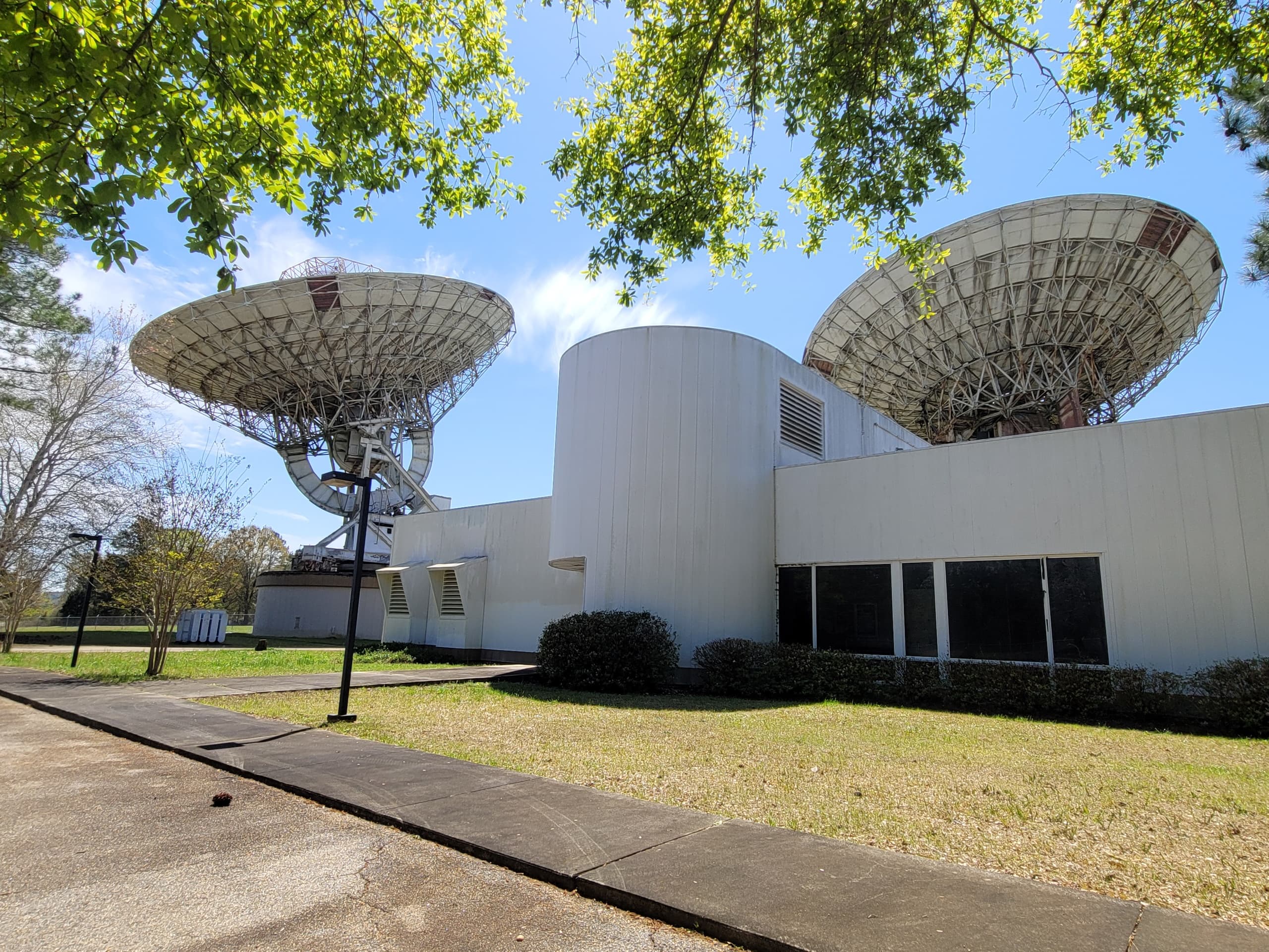 Satellite dish array at communications facility on sunny grounds