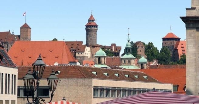 Medieval city skyline with castle towers, panoramic rooftop view