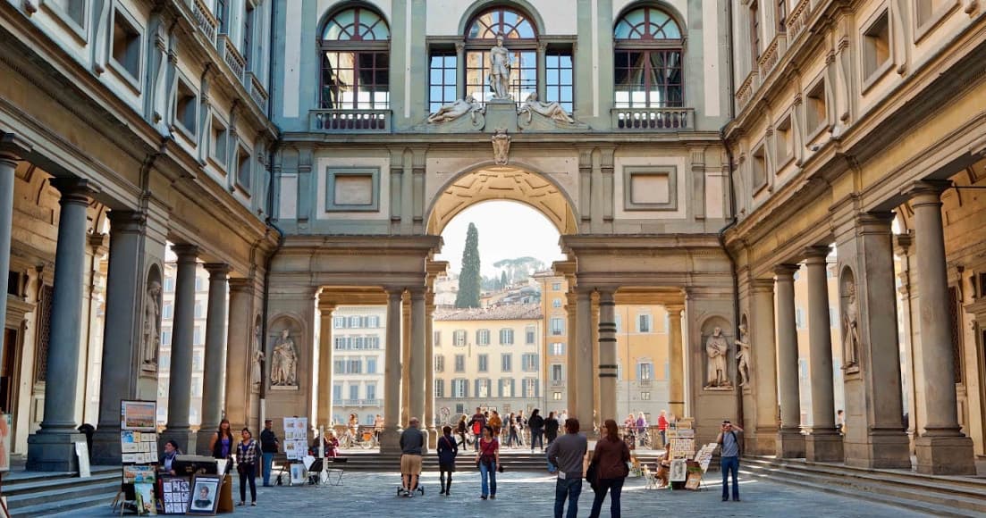 Historic Florentine arcade and plaza with walking tourists