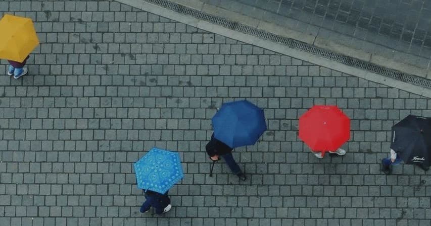 Aerial view of colorful umbrellas on Budapest cobblestone street