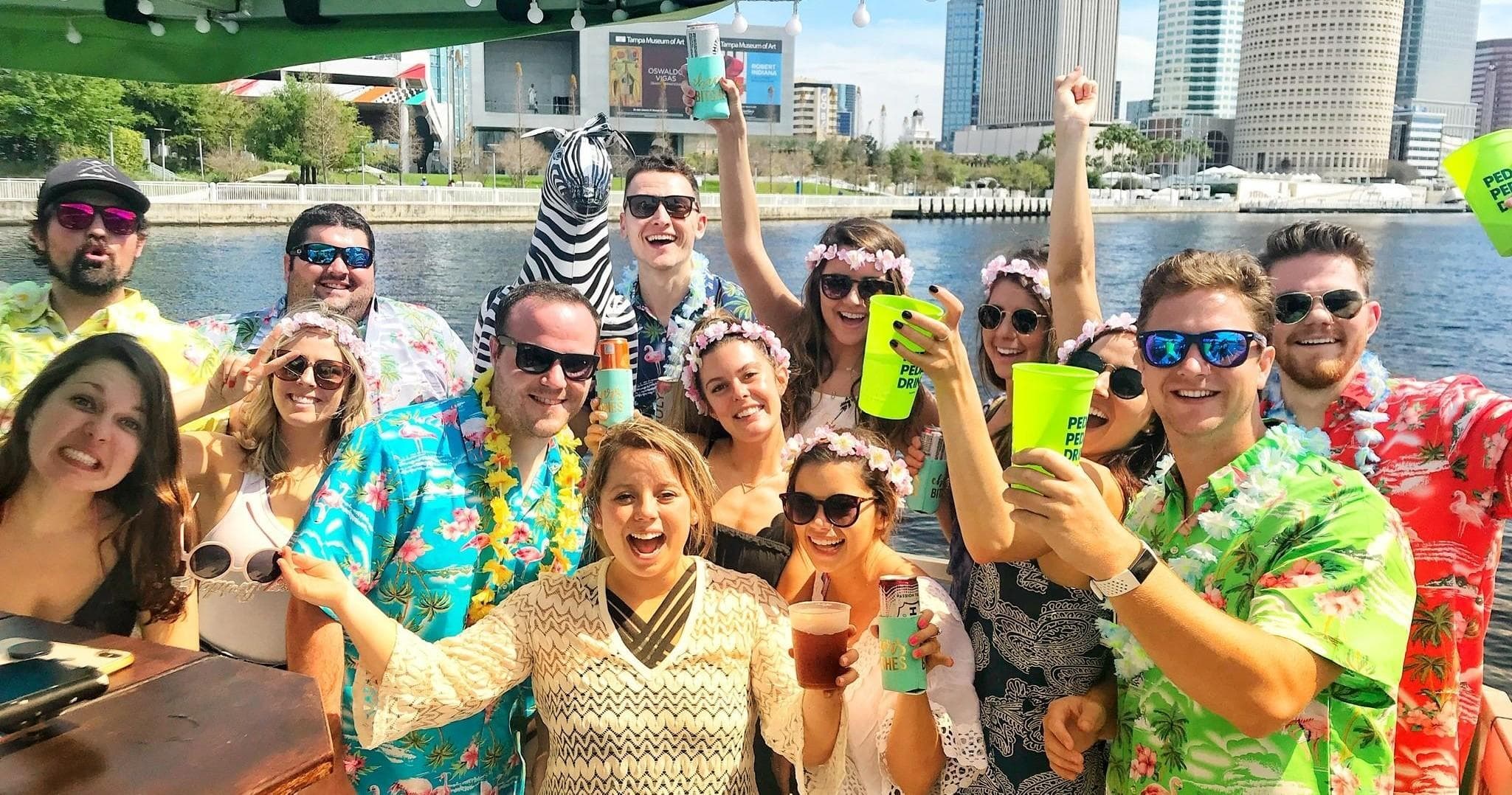 Group cruising on Tampa Riverwalk boat wearing Hawaiian shirts
