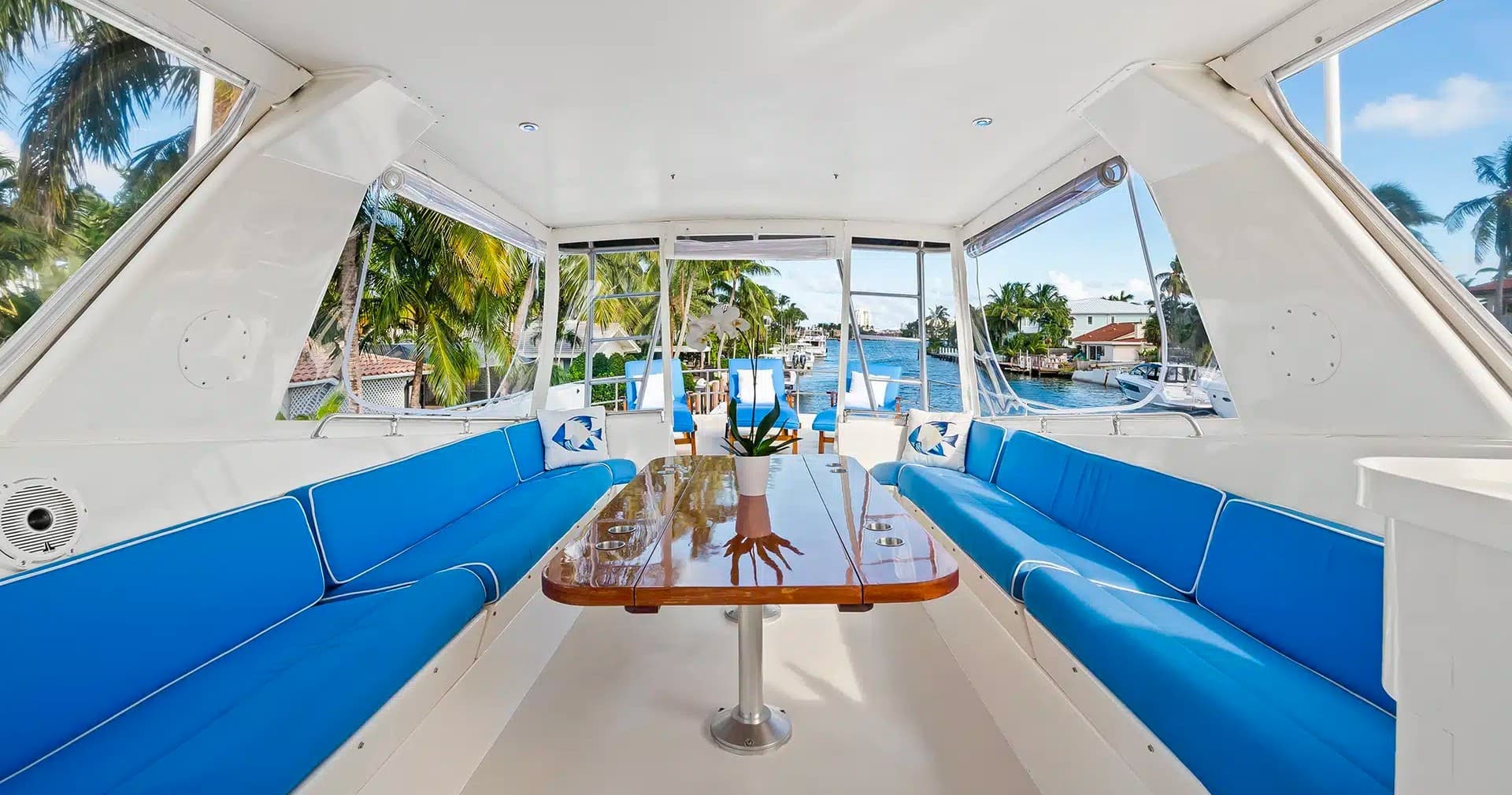 Yacht interior dining area with marina views and seating