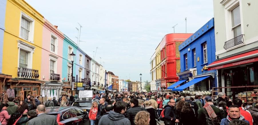 Crowded colorful market street in London on guided walking tour