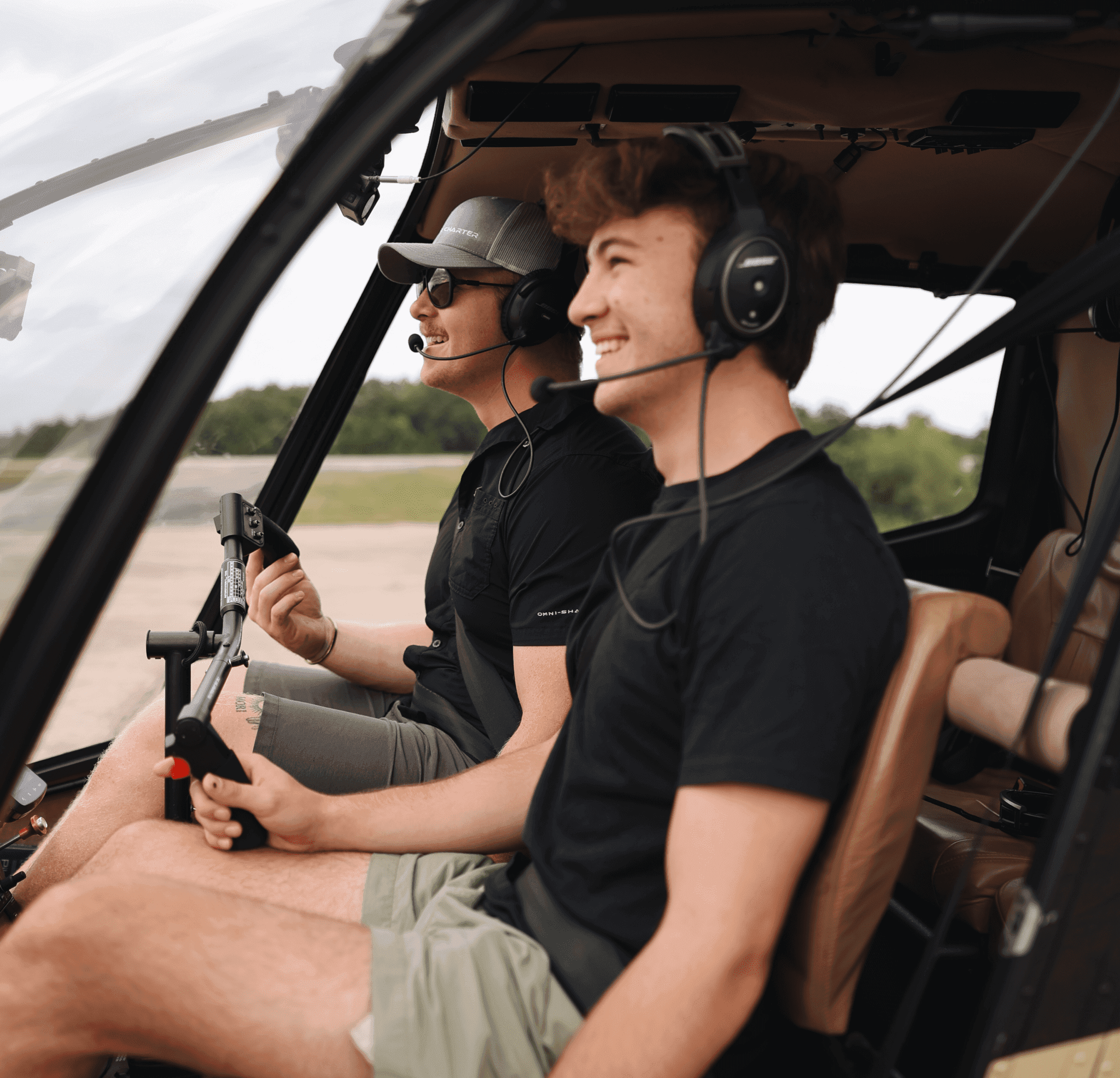 Smiling passengers enjoying guided helicopter tour flight