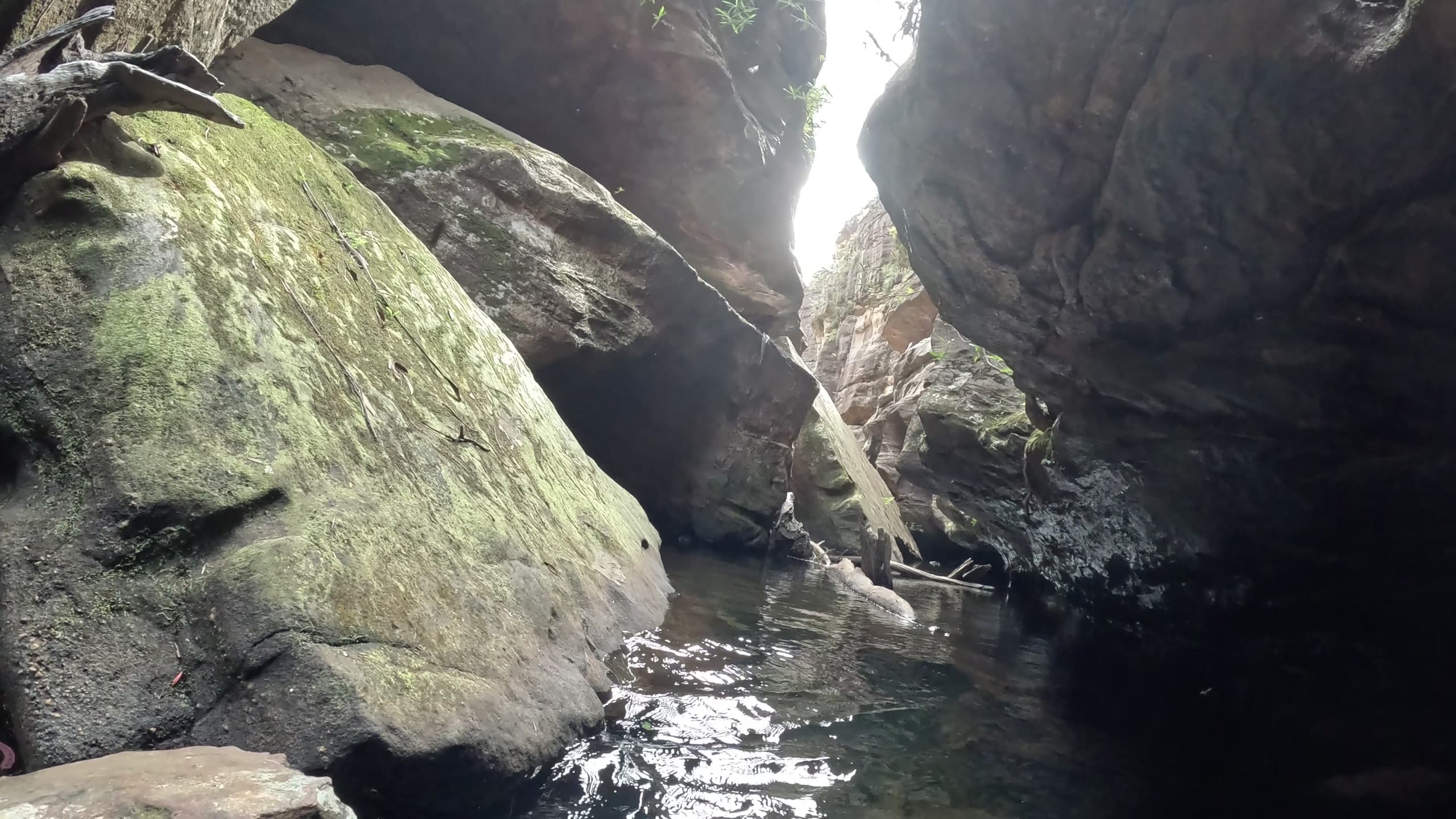 Canyon waterway opening with light shaft, canyon exploration