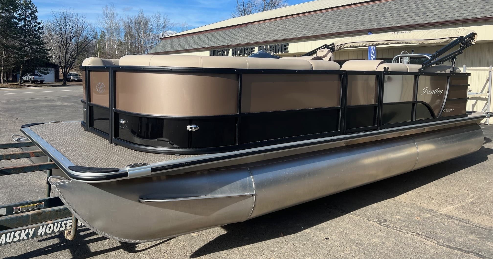 Luxury pontoon boat on trailer at marina parking, dry storage