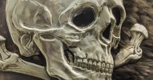 Detailed skull illustration on textured surface, macabre artwork