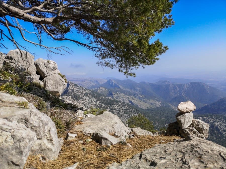 Rock arch viewpoint overlooking rugged Mallorca mountains, hiking scenery