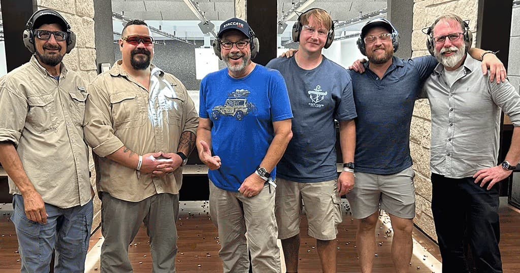 Instructors and students posing outdoors after firearms training