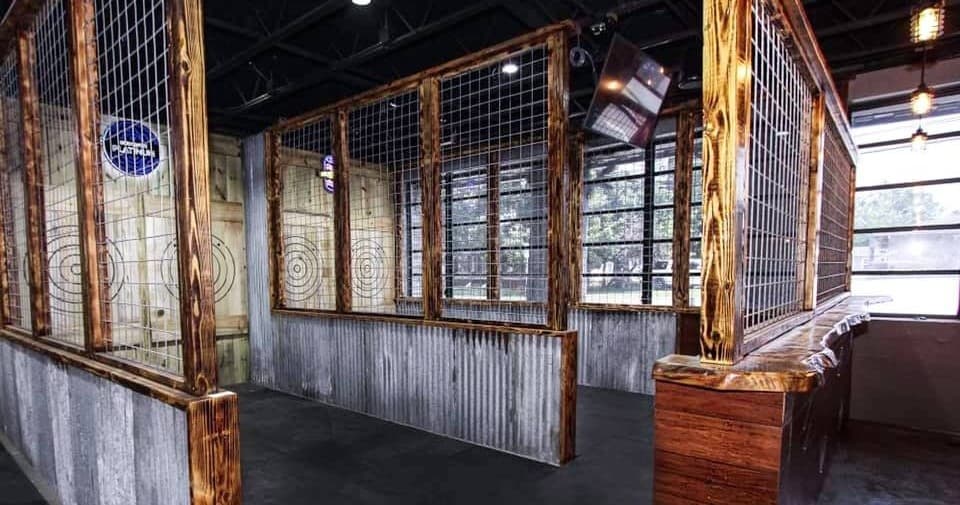 Indoor axe throwing booths with wire partitions and targets