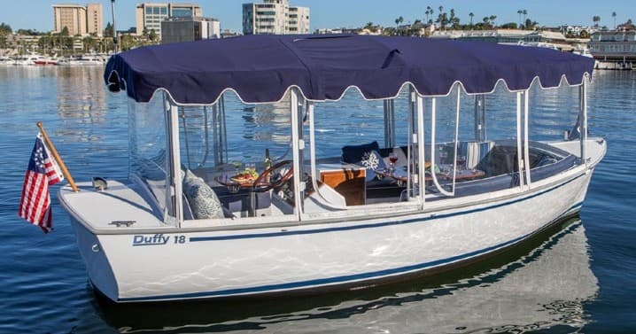 Electric Duffy sightseeing boat with canopy in harbor tour