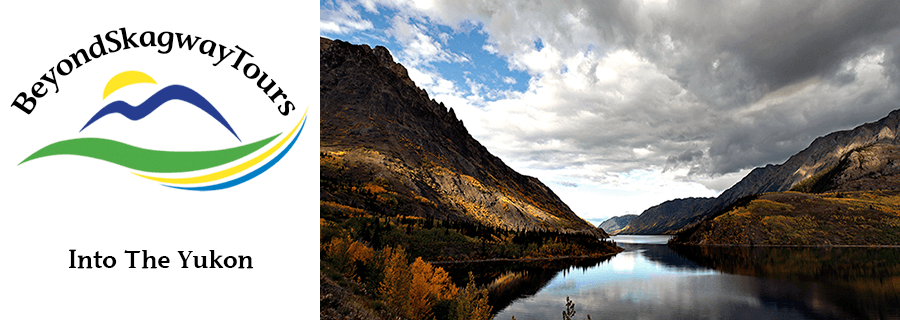 Mountain valley reflecting in calm lake with autumn foliage