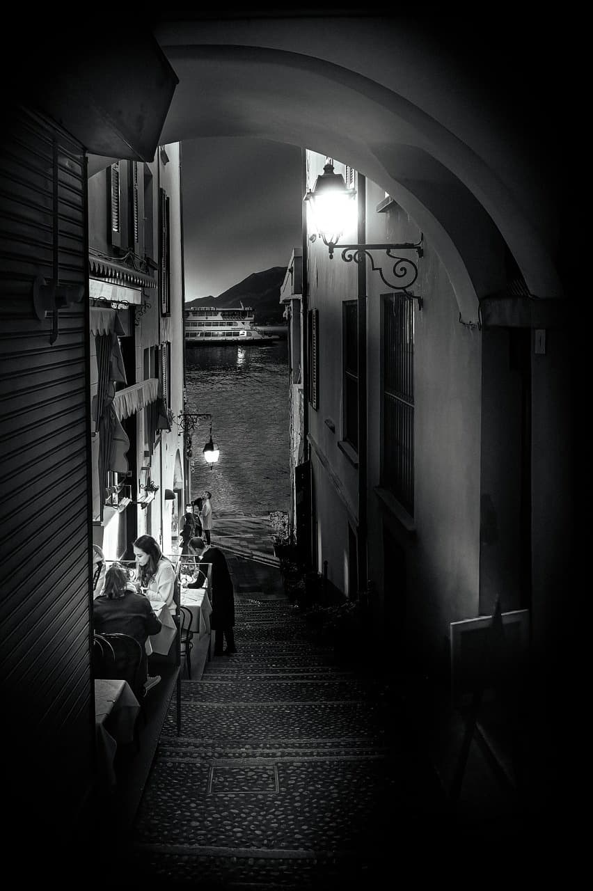 Black and white alleyway leading to lakeside in Como