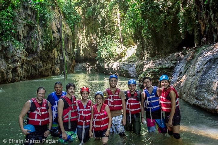Group canyoning in tropical river gorge in Puerto Rico