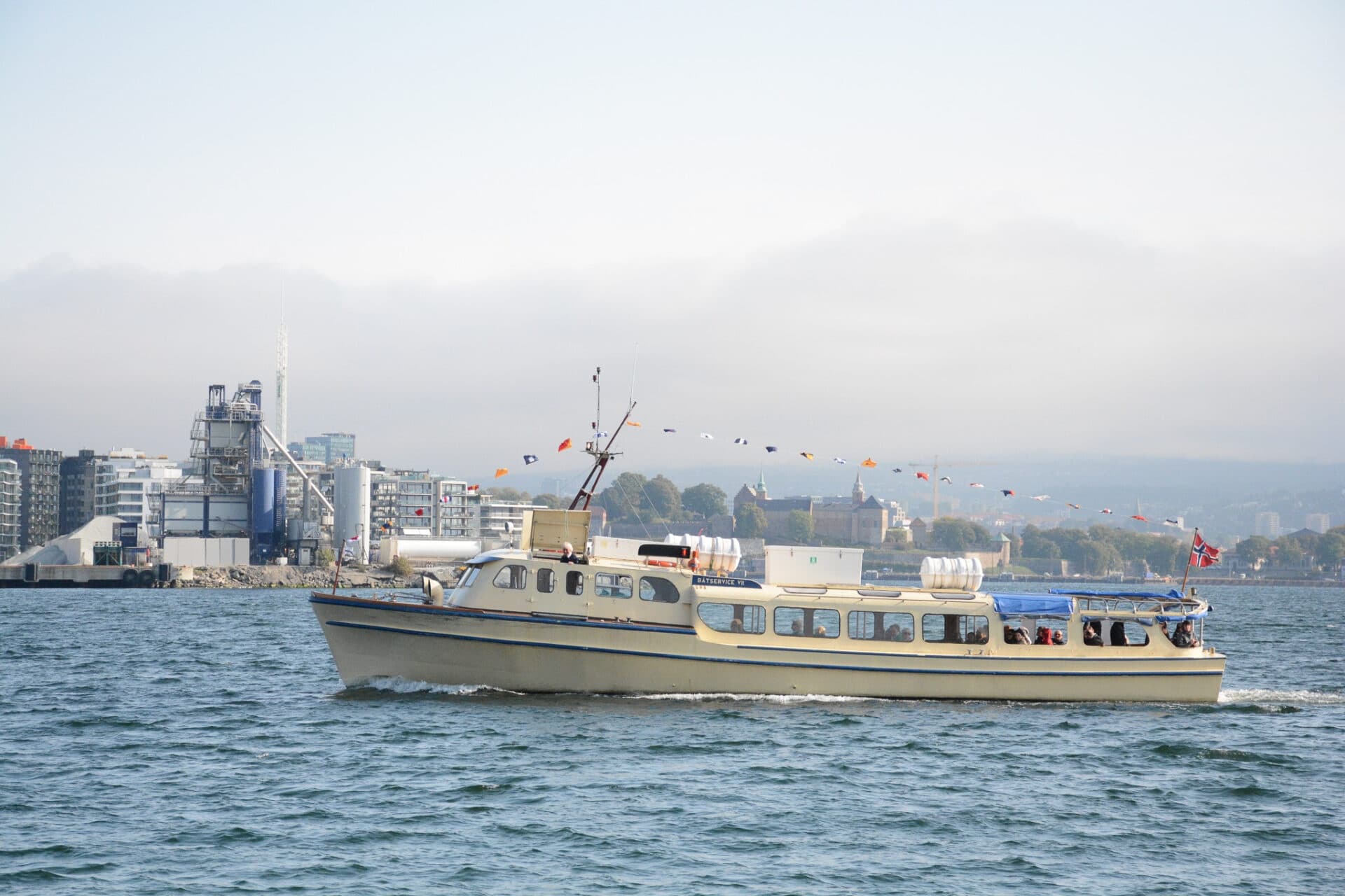 Passenger ferry cruising past city skyline on bay