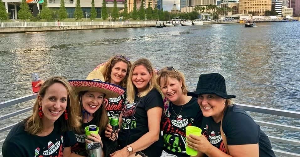 Women enjoying drinks on daylight cruise along Tampa waterway