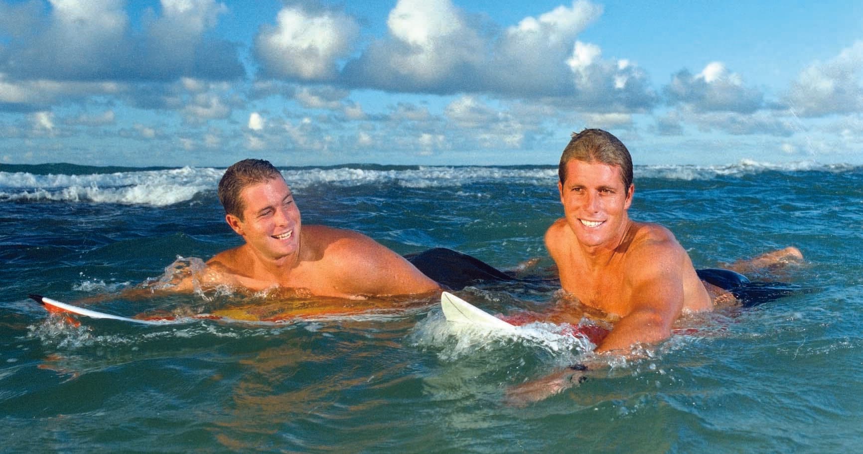 Surfer tube-riding a powerful breaking wave at ocean reef