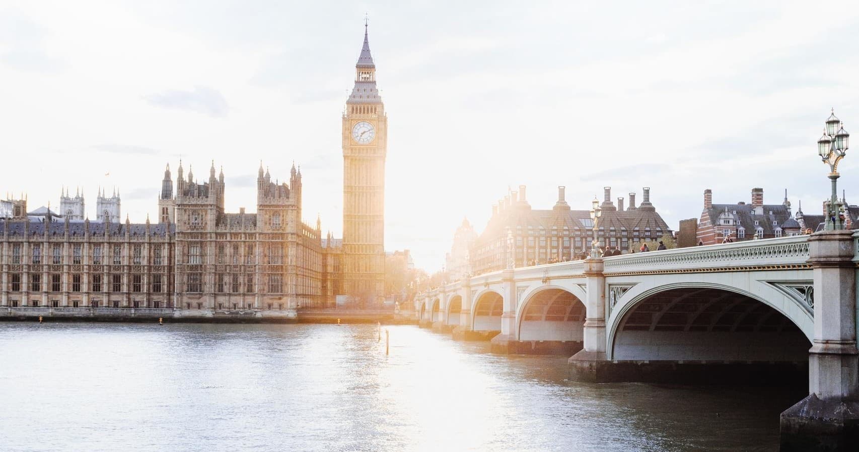 Westminster and Houses of Parliament along River Thames at sunrise
