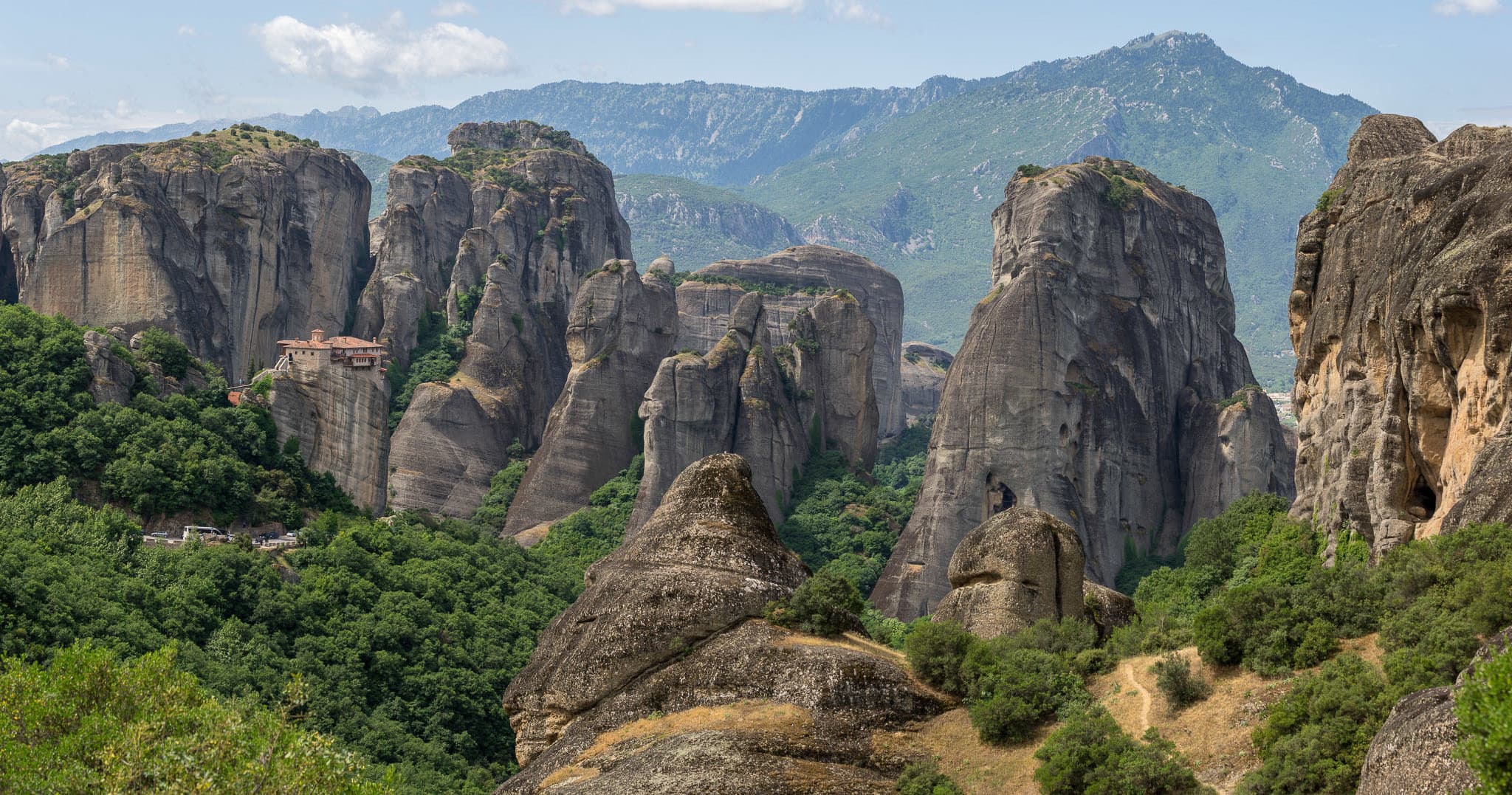 Panoramic Meteora rock formations and green mountain vistas