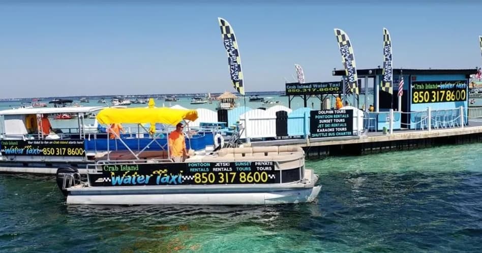 Water taxi docked in clear shallow Gulf waters at Crab Island