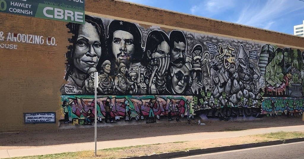 Large black and white street art mural on Phoenix brick wall