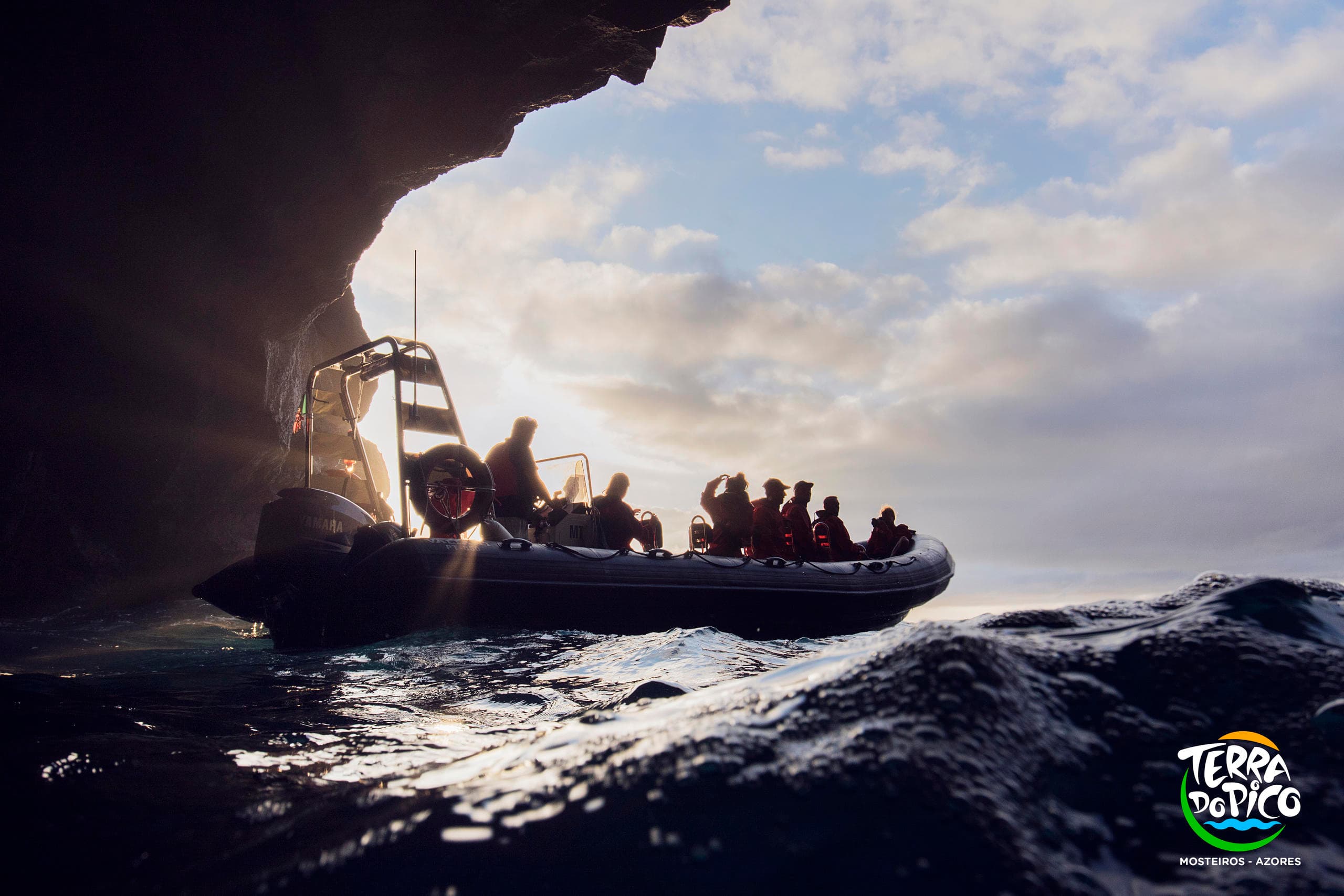 Zodiac boat exploring coastal cave on Azores adventure tour