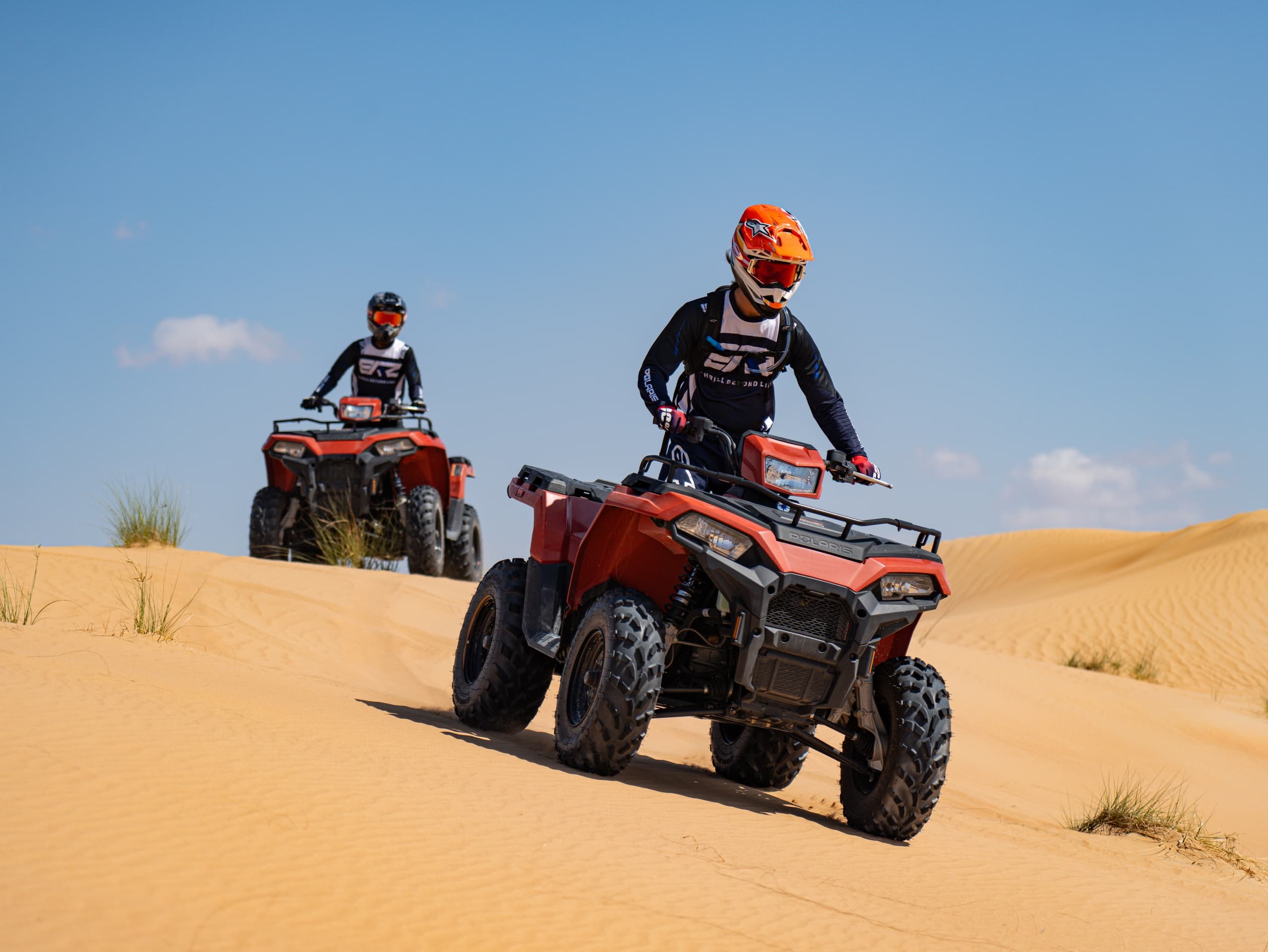 Side-by-side buggy traversing sandy dunes in Dubai desert