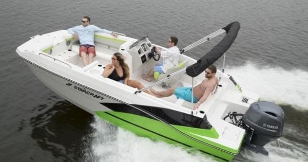 Small recreational bowrider boat cruising a calm river with friends