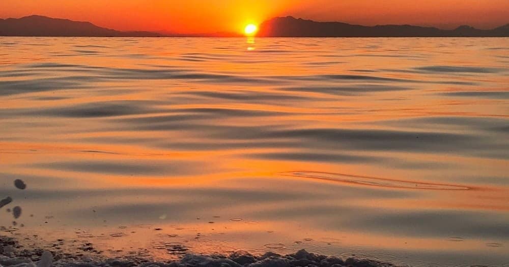 Sunset over calm Mediterranean sea, serene open-water view