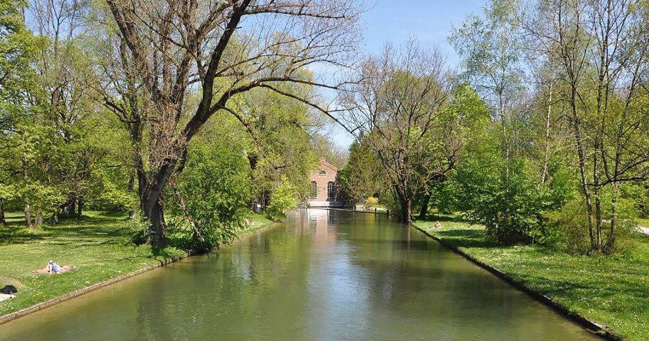 Scenic canal lined with trees for relaxed biking tours