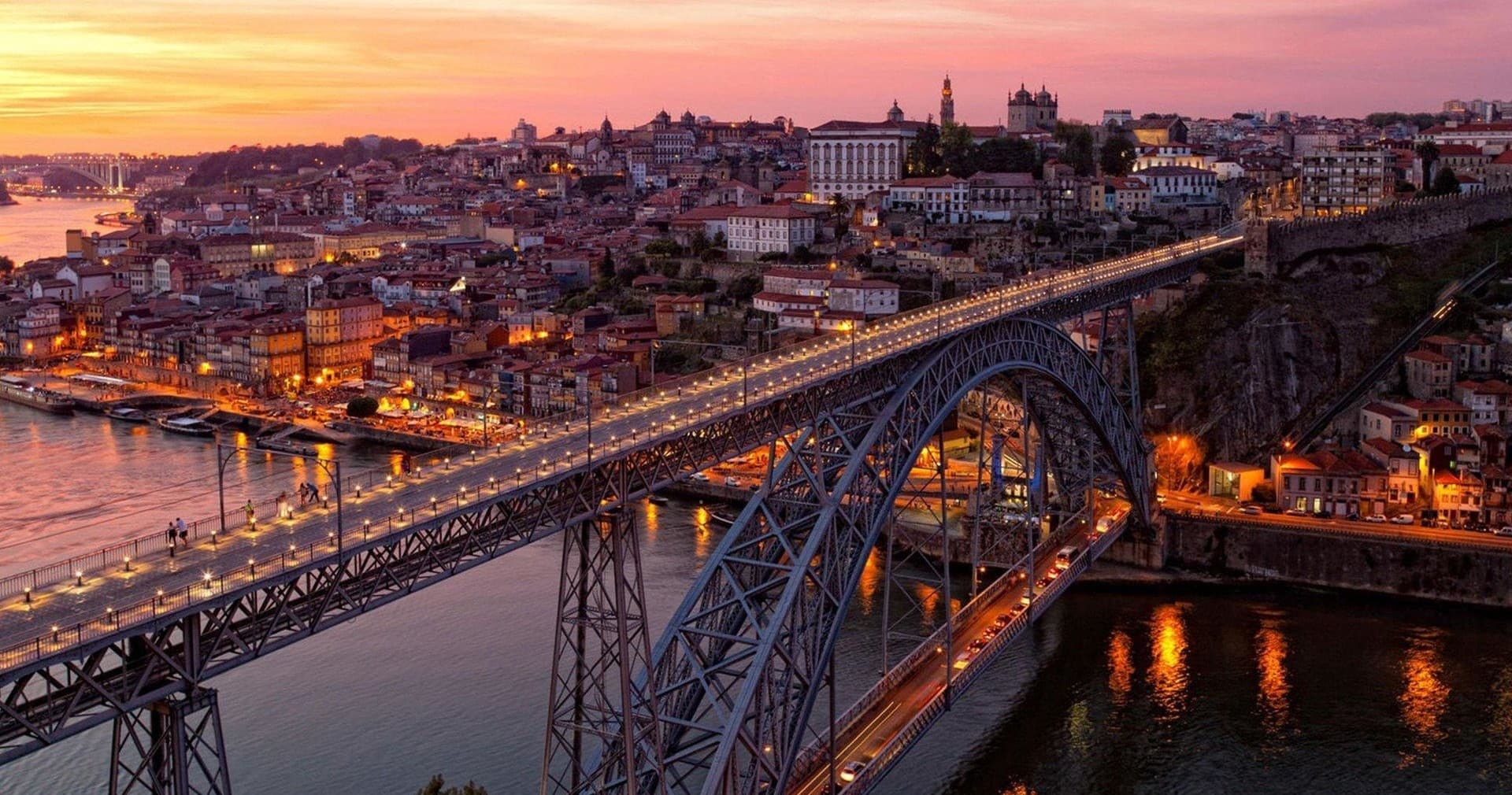 Sunset city bridge over river showcasing Porto skyline view