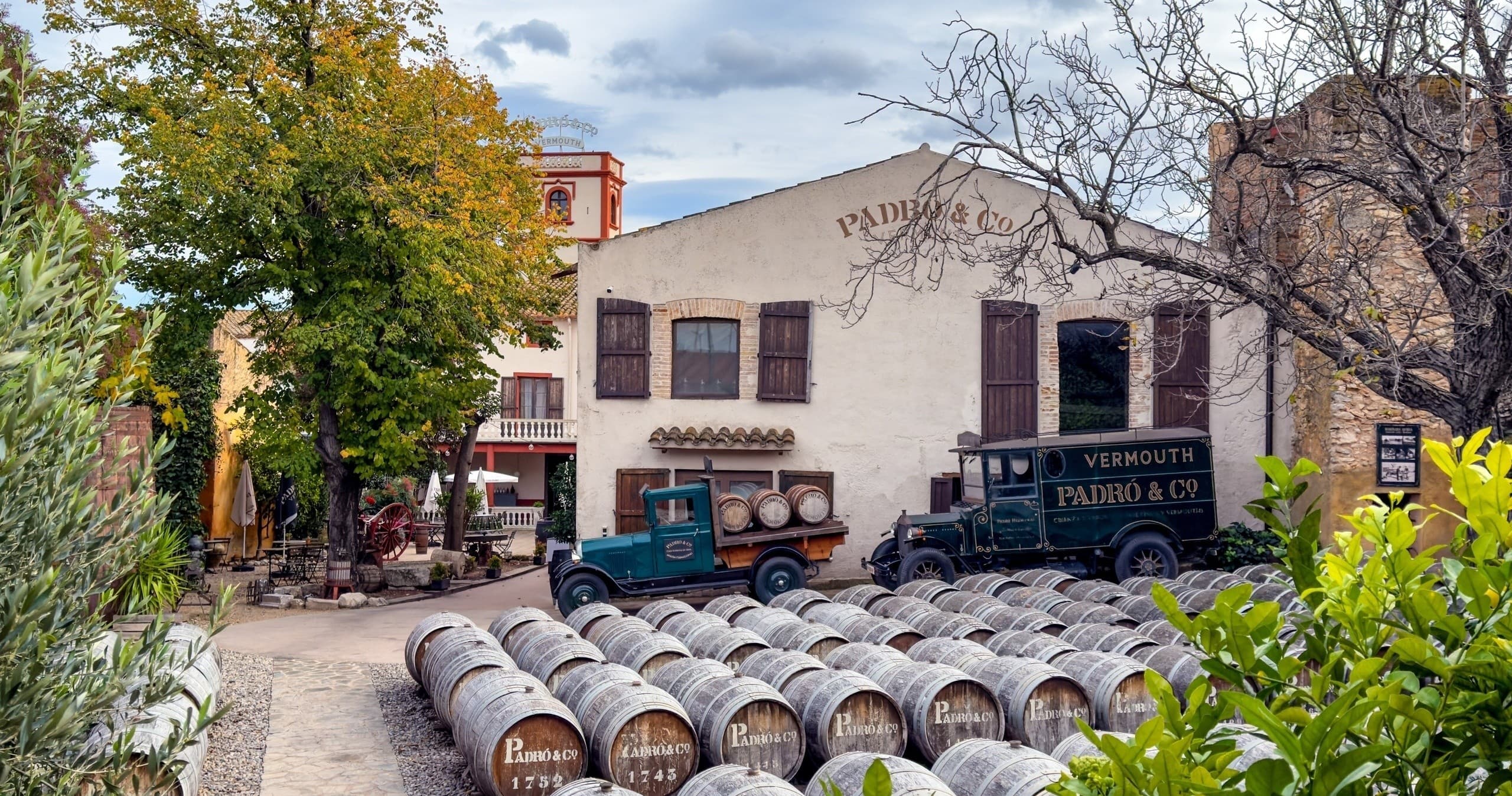 Historic Padro winery barrels and vintage truck in courtyard