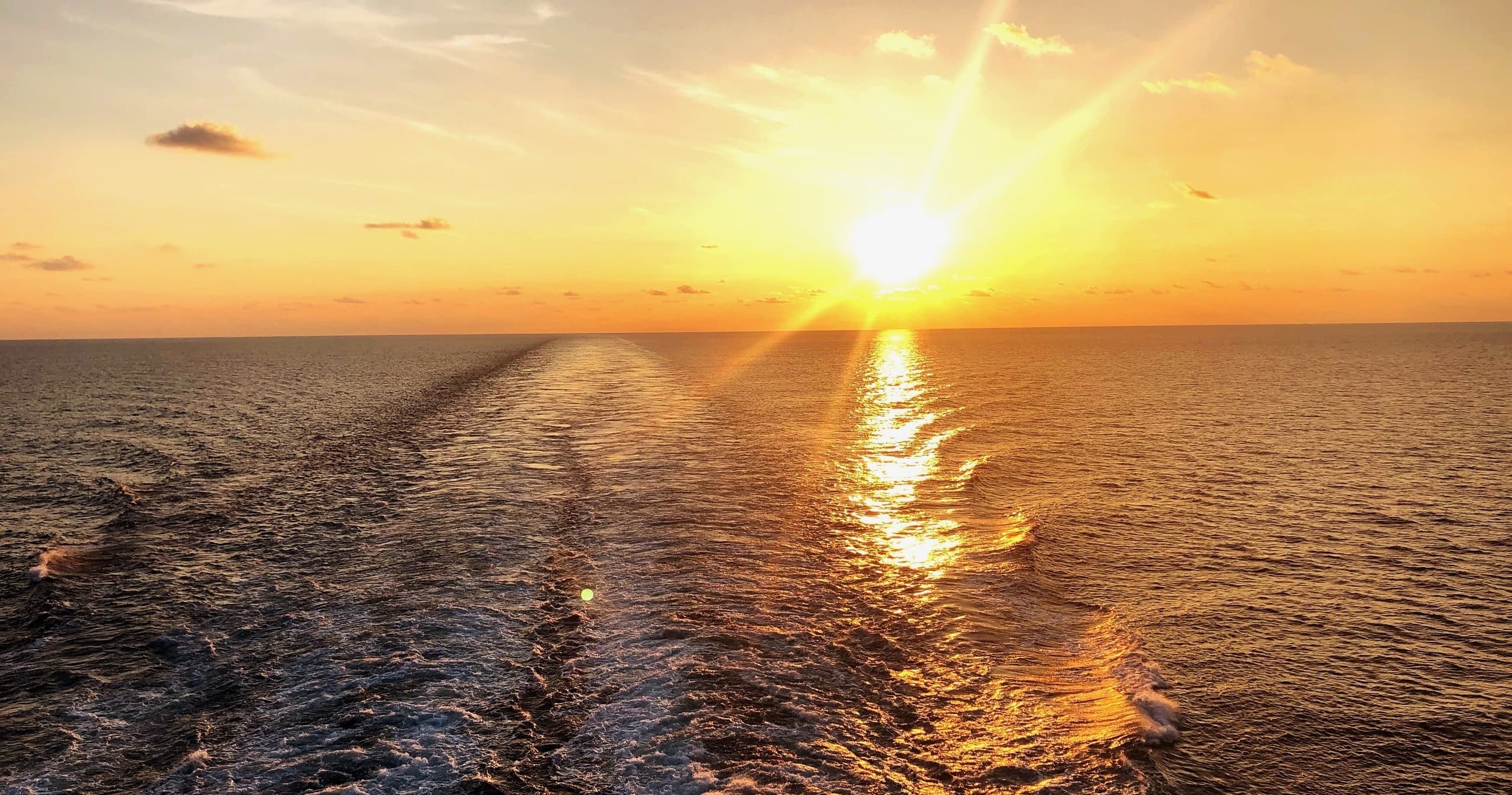 Sunset ship wake across open ocean for scenic soundside cruise