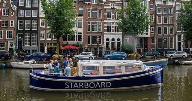Experience the Magic of Amsterdam Light Festival on a Cozy Electric Canal Cruise