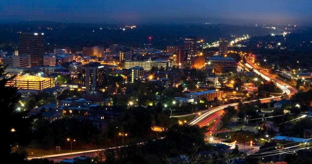 Nighttime city skyline with illuminated roads and lights