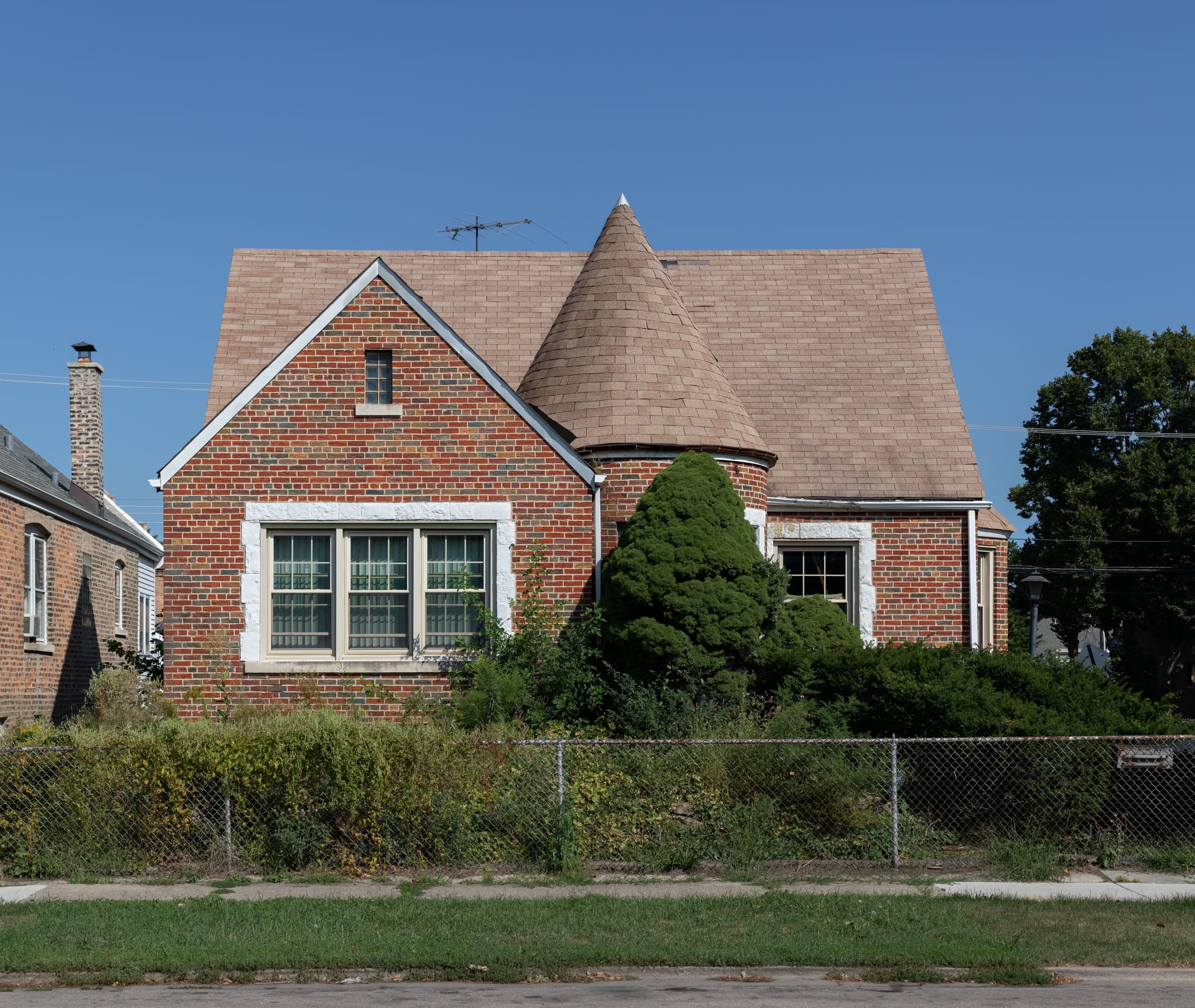 Historic brick Tudor house with turret in Chicago neighborhood