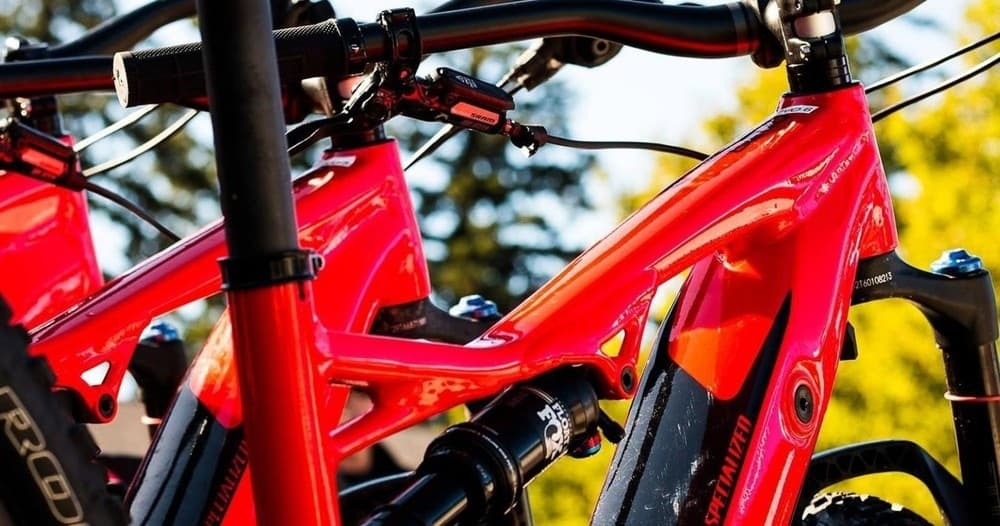 Close-up red mountain bike frame and suspension outdoors