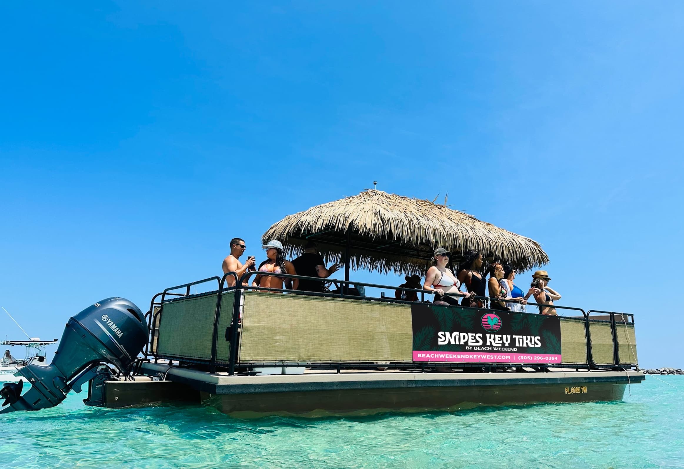 Tiki pontoon boat cruising turquoise Key West waters