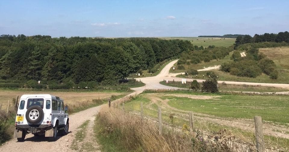 4x4 vehicle driving along chalk track across Salisbury Plain