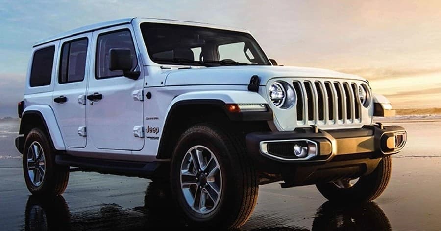 Jeep Wrangler on wet beach at sunset for coastal off-road adventure