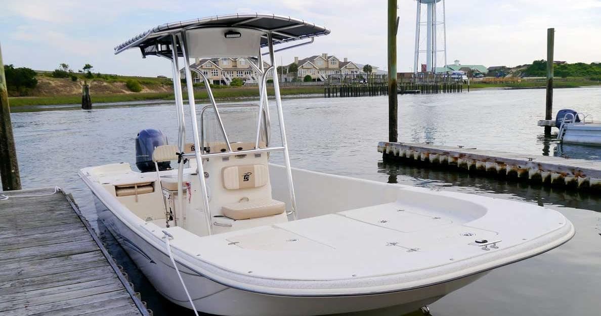 Center-console fishing boat docked at marina for offshore trips