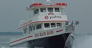 High-speed charter boat bow cutting through choppy coastal water