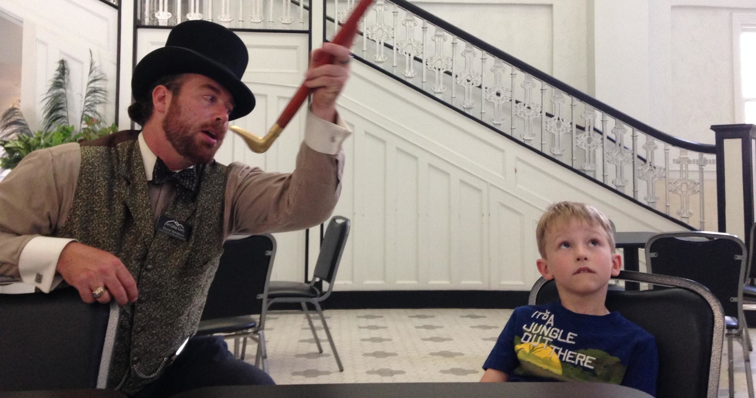 Historic tour performer engaging child indoors at Fort Collins venue