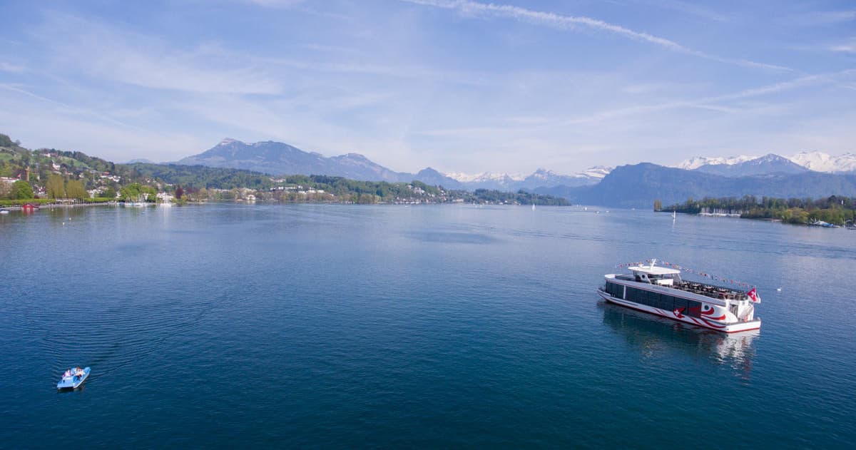 Scenic passenger ferry on alpine lake with mountain vistas